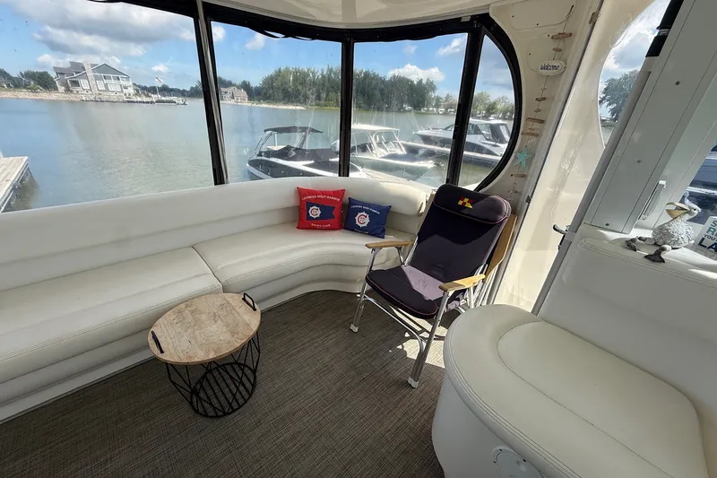 Slide: The Image of Interior of 2007 Sea Ray 40 Motor Yacht with white seating and lake view. - 35