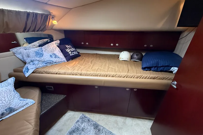 Slide: The Image of Cozy cabin interior of 2007 Sea Ray 40 Motor Yacht with pillows and helmets. - 80