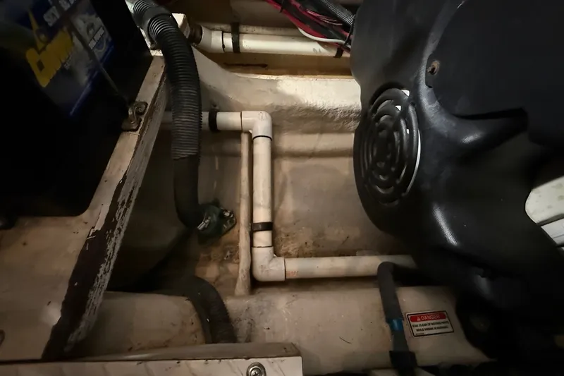 Slide: The Image of Engine compartment of a 2007 Sea Ray 40 Motor Yacht, showing pipes and wiring. - 103