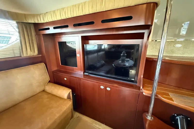 Slide: The Image of Interior of 2007 Sea Ray 40 Motor Yacht with wood cabinetry and TV. - 57