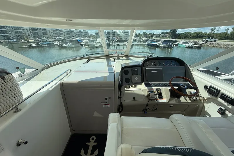 Slide: The Image of 2007 Sea Ray 40 Motor Yacht helm with marina view, featuring modern navigation equipment. - 39