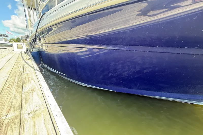 Slide: The Image of 2007 Sea Ray 40 Motor Yacht docked, showcasing sleek blue hull design. - 15