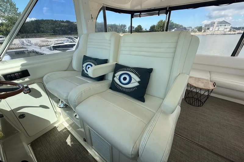 Slide: The Image of 2007 Sea Ray 40 Motor Yacht interior with white seating and decorative eye pillows. - 41