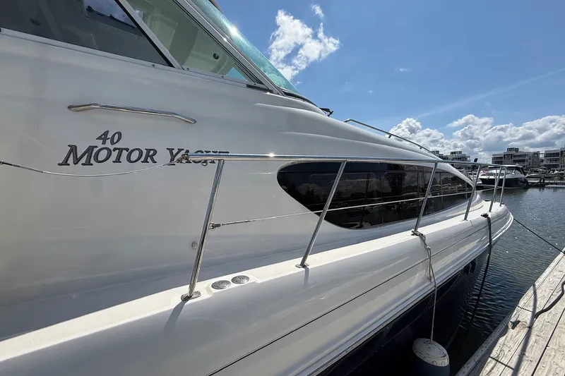 Slide: The Image of 2007 Sea Ray 40 Motor Yacht docked under a clear blue sky. - 11
