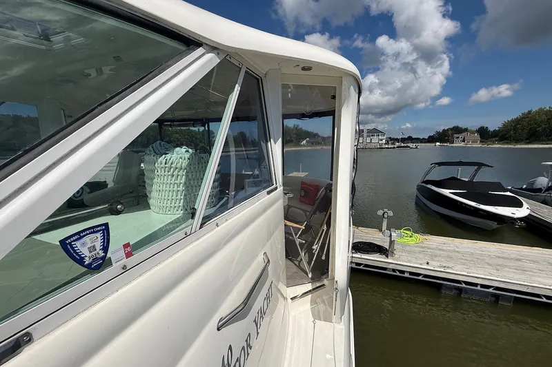 Slide: The Image of 2007 Sea Ray 40 Motor Yacht docked at a marina under a blue sky. - 23