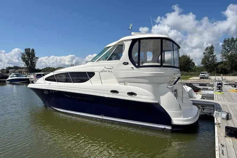 The Image of 2007 Sea Ray 40 Motor Yacht docked in a marina under a partly cloudy sky. - 1