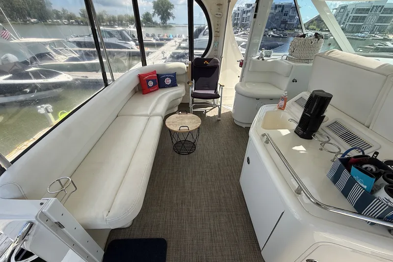 Slide: The Image of Interior of a 2007 Sea Ray 40 Motor Yacht with white seating and modern amenities. - 28