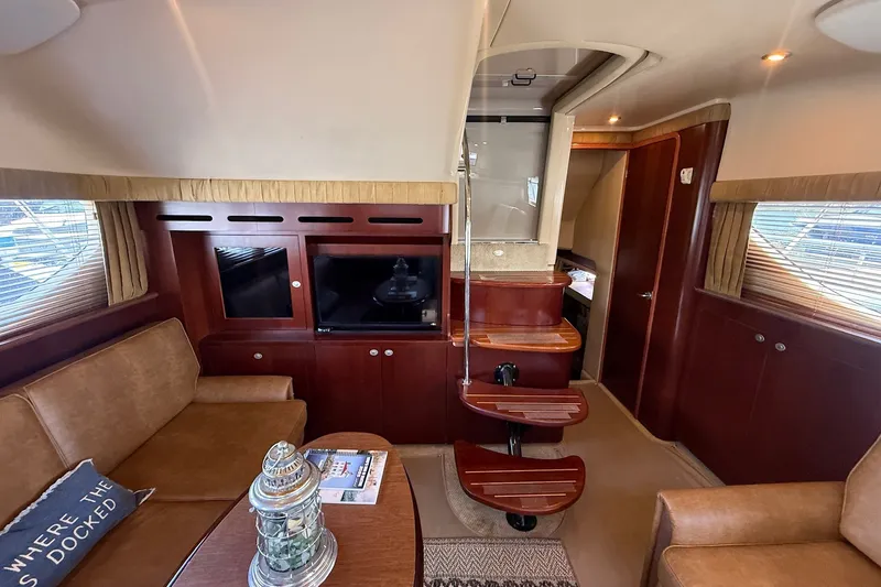 Slide: The Image of Interior of 2007 Sea Ray 40 Motor Yacht with elegant wood finishes and cozy seating. - 56