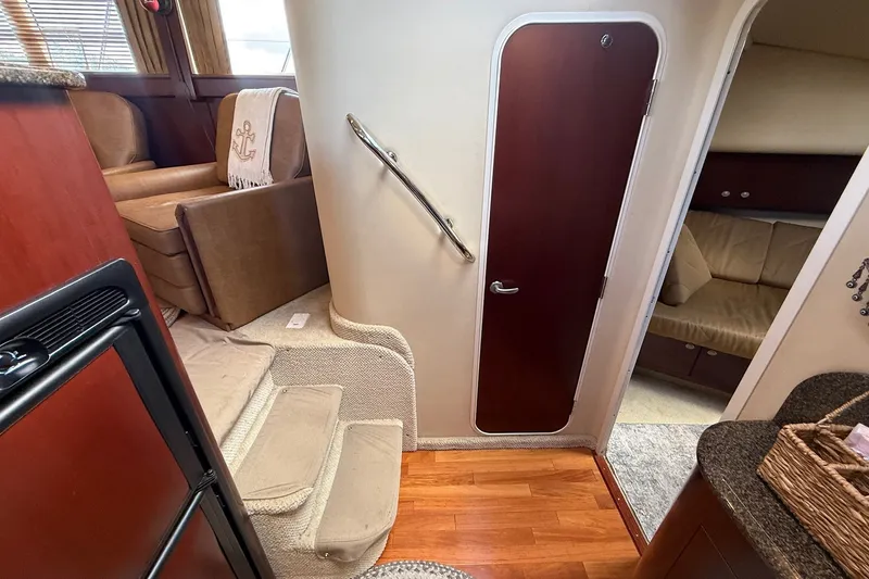 Slide: The Image of Interior of 2007 Sea Ray 40 Motor Yacht with stairs, seating, and wooden flooring. - 70