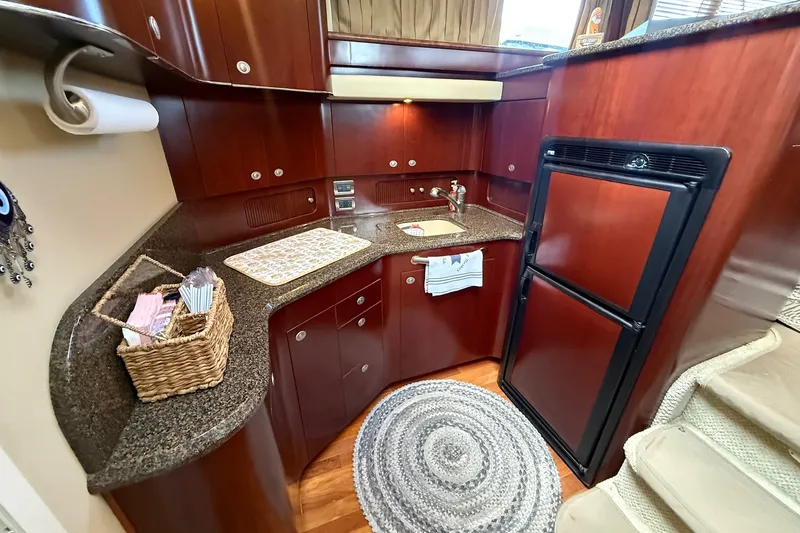 Slide: The Image of Luxurious 2007 Sea Ray 40 Motor Yacht kitchen with wood cabinetry and modern appliances. - 76