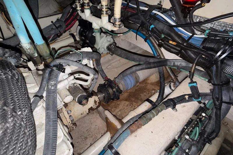 Slide: The Image of Engine compartment of a 2007 Sea Ray 40 Motor Yacht with visible wiring and hoses. - 115