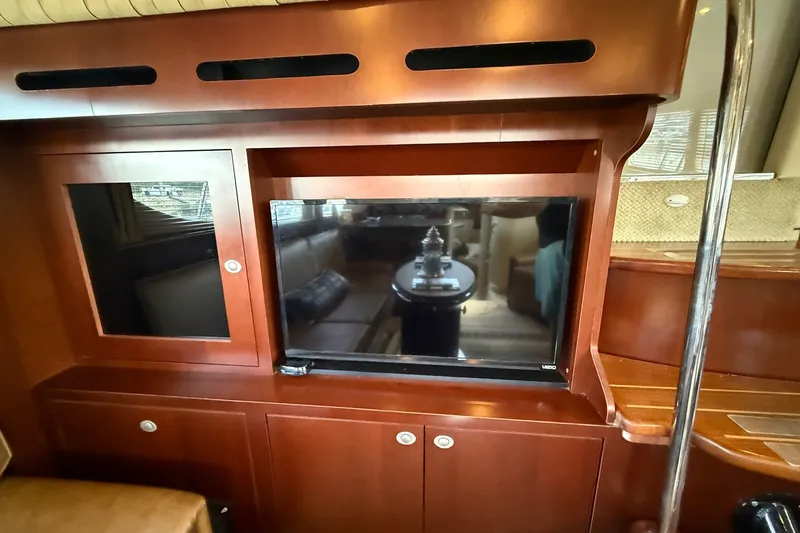 Slide: The Image of Interior of 2007 Sea Ray 40 Motor Yacht with wooden cabinetry and built-in TV. - 58