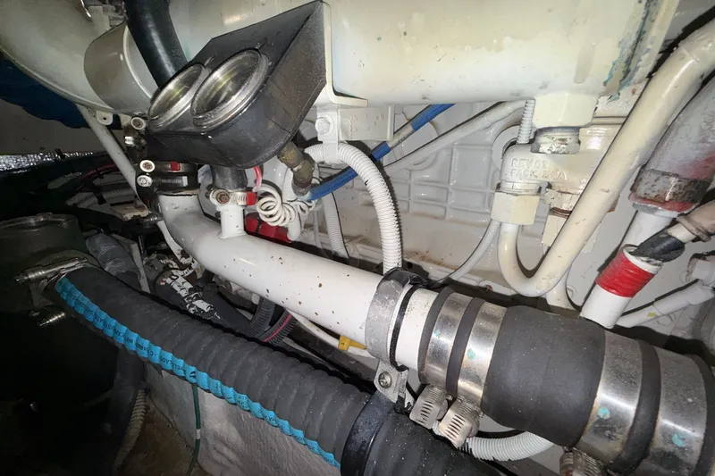 Slide: The Image of Engine compartment of a 2007 Sea Ray 40 Motor Yacht, showcasing hoses and fittings. - 113