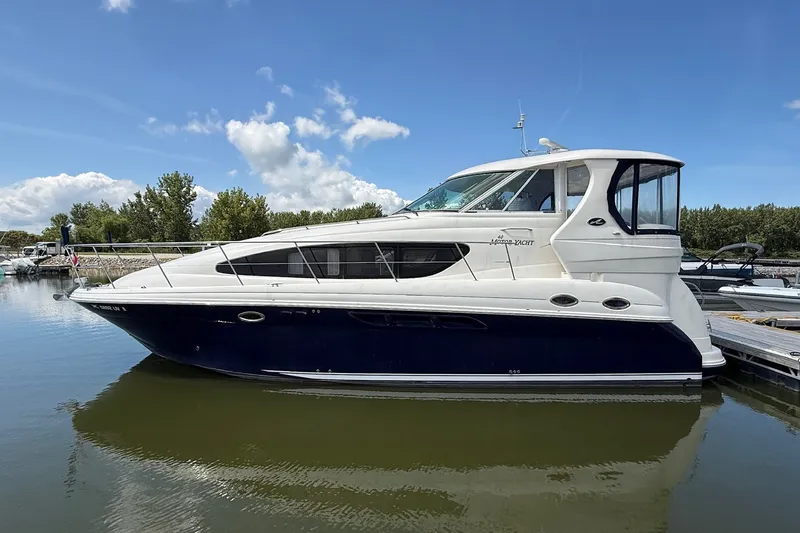Slide: The Image of 2007 Sea Ray 40 Motor Yacht docked on calm water under a clear blue sky. - 117