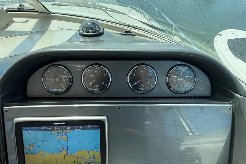 Slide: The Image of Dashboard of a 2007 Sea Ray 40 Motor Yacht with gauges and navigation display. - 49