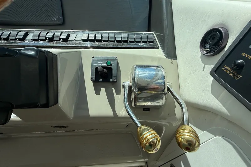 Slide: The Image of Control panel of a 2007 Sea Ray 40 Motor Yacht with throttle levers and bow thruster. - 44
