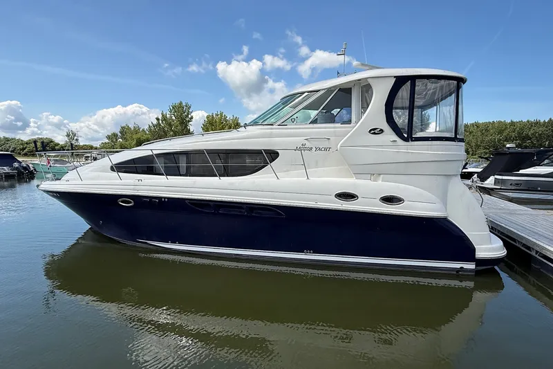 Slide: The Image of 2007 Sea Ray 40 Motor Yacht docked on calm water under a clear sky. - 119