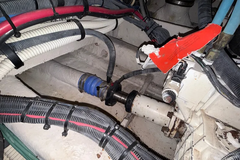 Slide: The Image of Engine compartment of a 2007 Sea Ray 40 Motor Yacht, showing cables and mechanical components. - 116