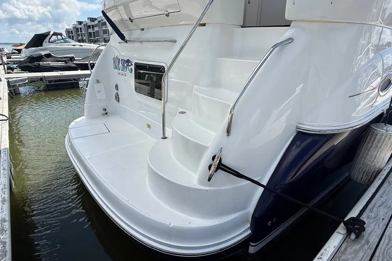 Slide: The Image of 2007 Sea Ray 40 Motor Yacht docked, featuring sleek white exterior and rear steps. - 7