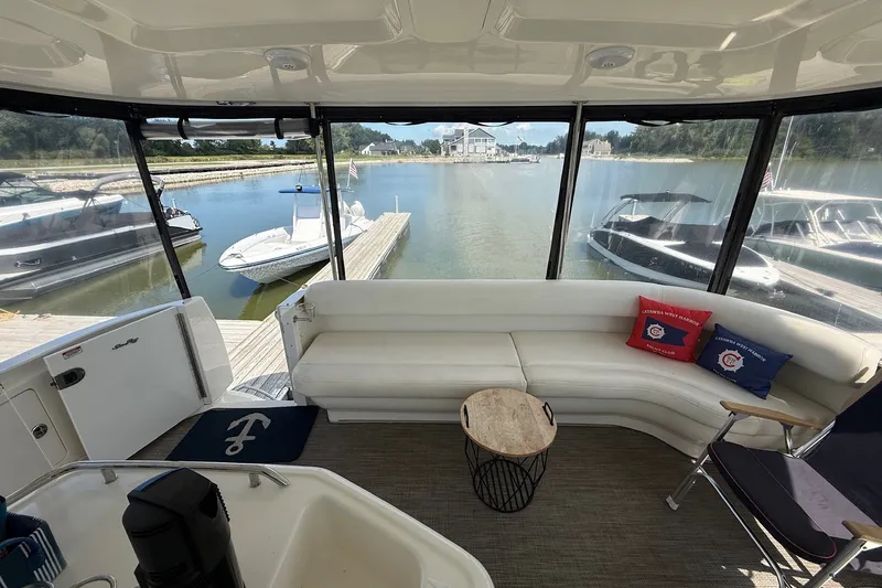 Slide: The Image of Interior of 2007 Sea Ray 40 Motor Yacht with white seating and marina view. - 33