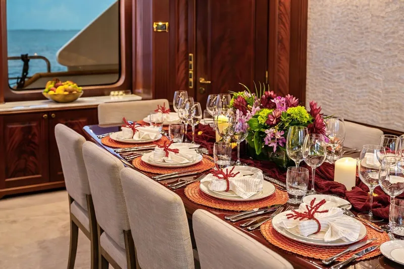 Slide: The Image of Luxurious dining setup on 2007 Benetti 120 Classic yacht with elegant tableware and floral centerpiece. - 152