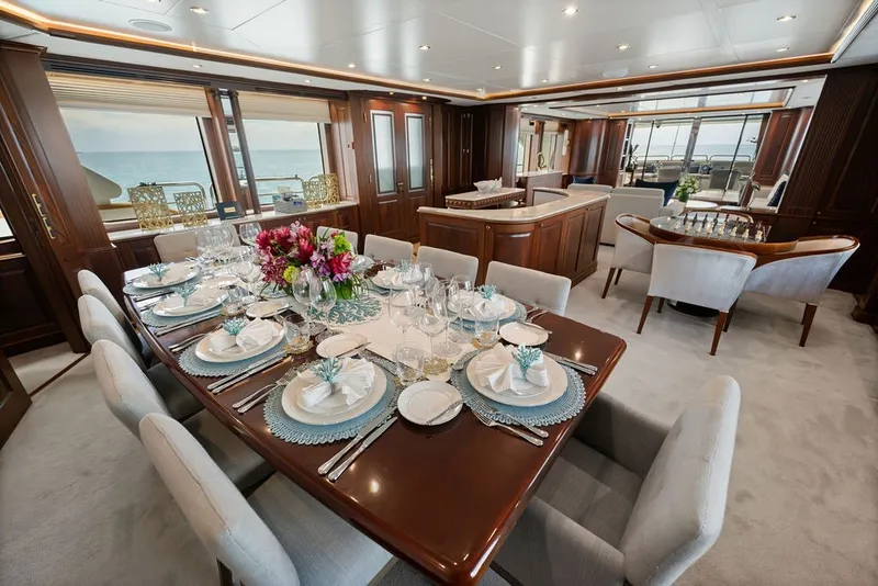 Slide: The Image of Luxurious dining area on a 2007 Benetti 120 Classic yacht with elegant table setting. - 69