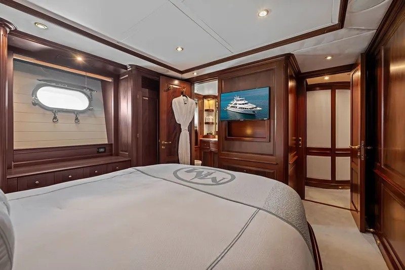 Slide: The Image of Luxurious bedroom interior on a 2007 Benetti 120 Classic yacht with elegant wood paneling. - 113