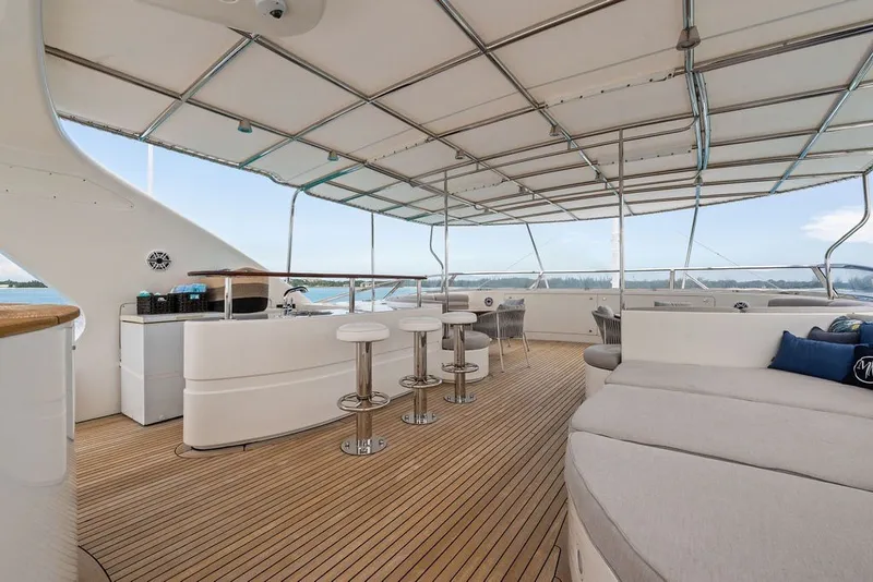 Slide: The Image of Luxurious 2007 Benetti 120 Classic yacht deck with bar, seating, and panoramic views. - 48