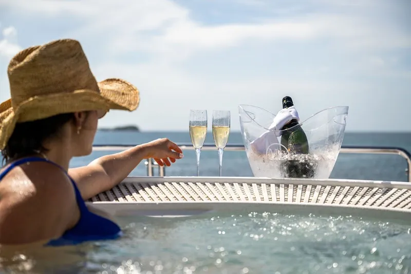 Slide: The Image of Woman relaxing in a hot tub on a 2007 Benetti 120 Classic yacht with champagne. - 167