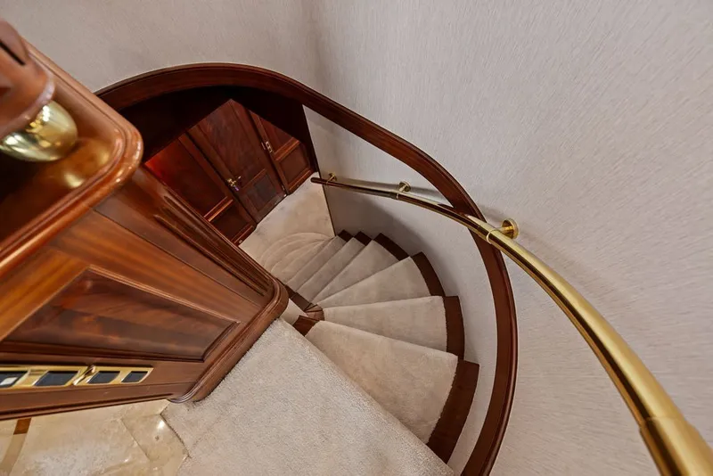 Slide: The Image of Luxurious spiral staircase with wooden and brass accents on a 2007 Benetti 120 Classic yacht. - 110