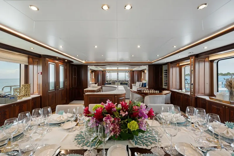 Slide: The Image of Luxurious interior of 2007 Benetti 120 Classic yacht with elegant dining setup and floral centerpiece. - 70