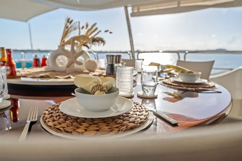 Slide: The Image of Elegant dining setup on a 2007 Benetti 120 Classic yacht, overlooking the ocean. - 145