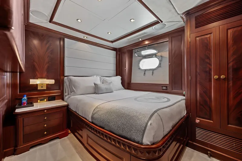 Slide: The Image of Luxurious bedroom interior on a 2007 Benetti 120 Classic yacht, featuring elegant wood paneling. - 125