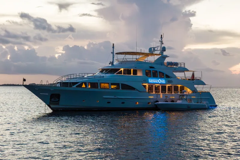 Slide: The Image of Luxurious 2007 Benetti 120 Classic yacht illuminated at sunset on calm waters. - 17
