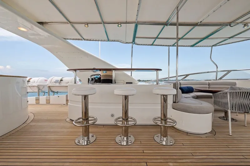 Slide: The Image of Luxurious deck of 2007 Benetti 120 Classic yacht with bar stools and seating area. - 49