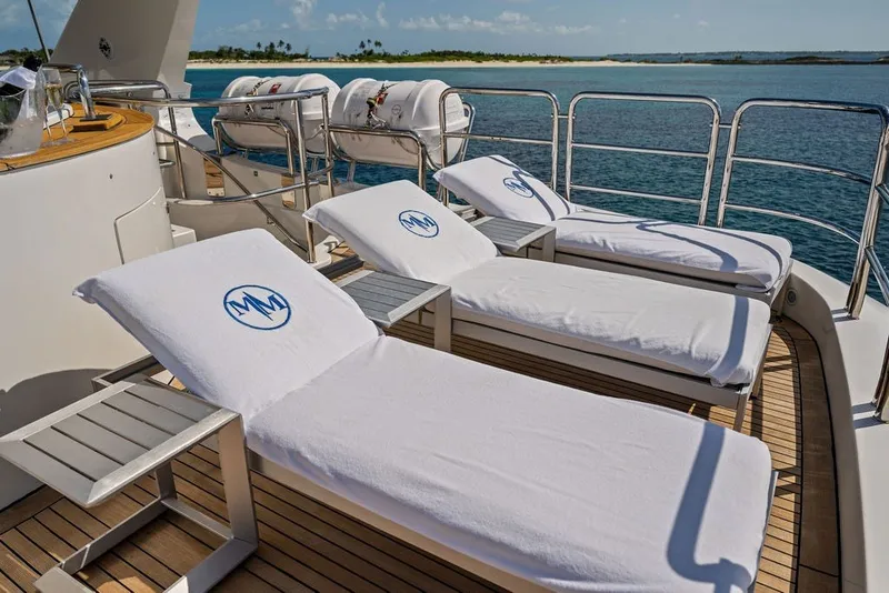 Slide: The Image of Sun loungers on the deck of a 2007 Benetti 120 Classic yacht, overlooking the ocean. - 53