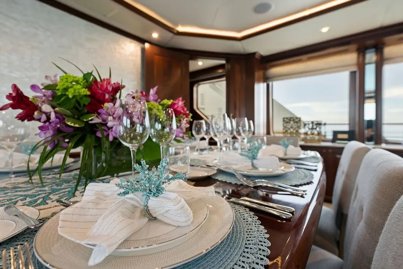 Slide: The Image of Elegant dining setup on 2007 Benetti 120 Classic yacht with floral centerpiece and fine tableware. - 67