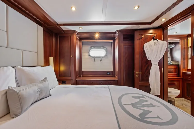 Slide: The Image of Luxurious bedroom interior on 2007 Benetti 120 Classic yacht, featuring elegant wood finishes. - 122