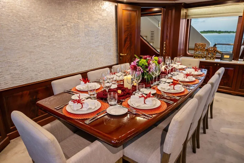Slide: The Image of Luxurious dining setup on 2007 Benetti 120 Classic yacht, featuring elegant tableware and floral centerpiece. - 143
