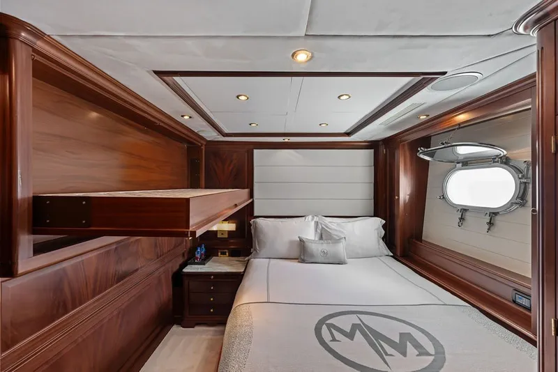 Slide: The Image of Luxurious bedroom interior on a 2007 Benetti 120 Classic yacht, featuring elegant wood paneling. - 136