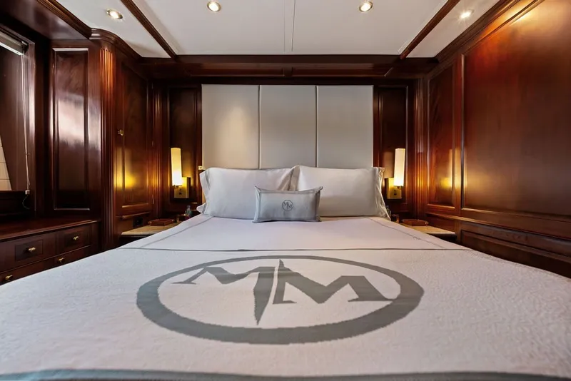 Slide: The Image of Luxurious bedroom interior on a 2007 Benetti 120 Classic yacht, featuring elegant wood paneling. - 116