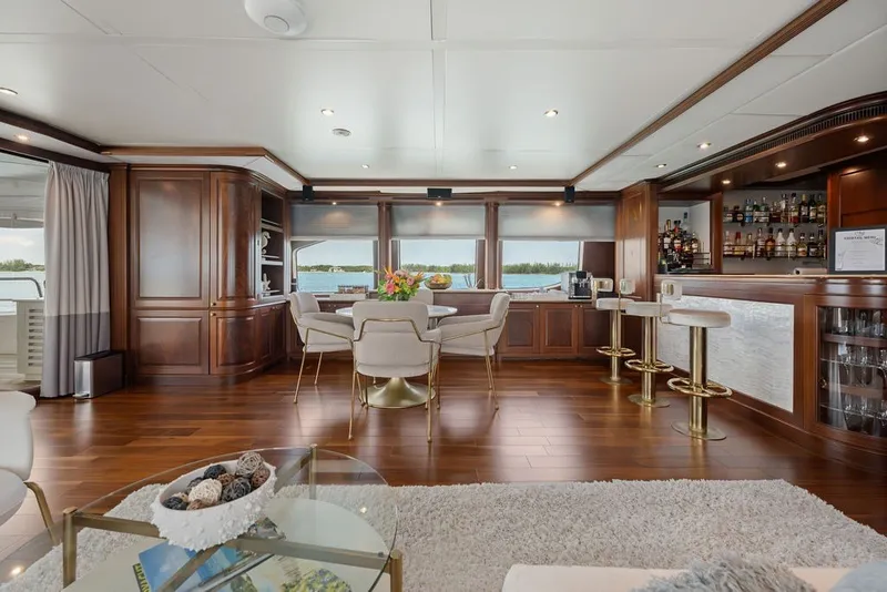 Slide: The Image of Luxurious interior of 2007 Benetti 120 Classic yacht with elegant wood finishes and bar area. - 76