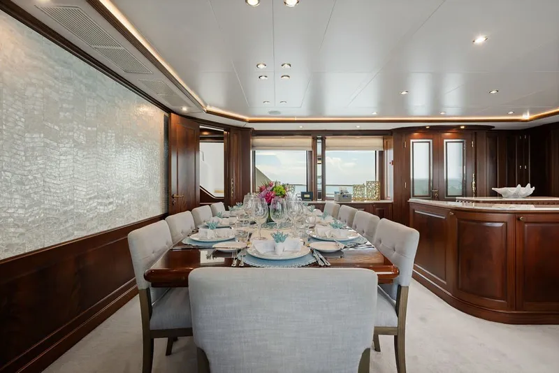 Slide: The Image of Luxurious dining area on 2007 Benetti 120 Classic yacht, featuring elegant table setting and wood paneling. - 68