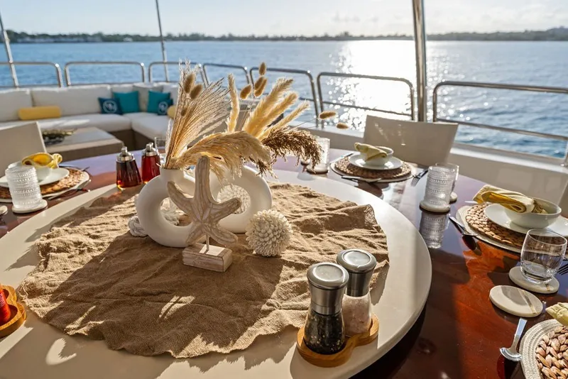 Slide: The Image of Elegant dining setup on 2007 Benetti 120 Classic yacht, overlooking serene ocean view. - 146