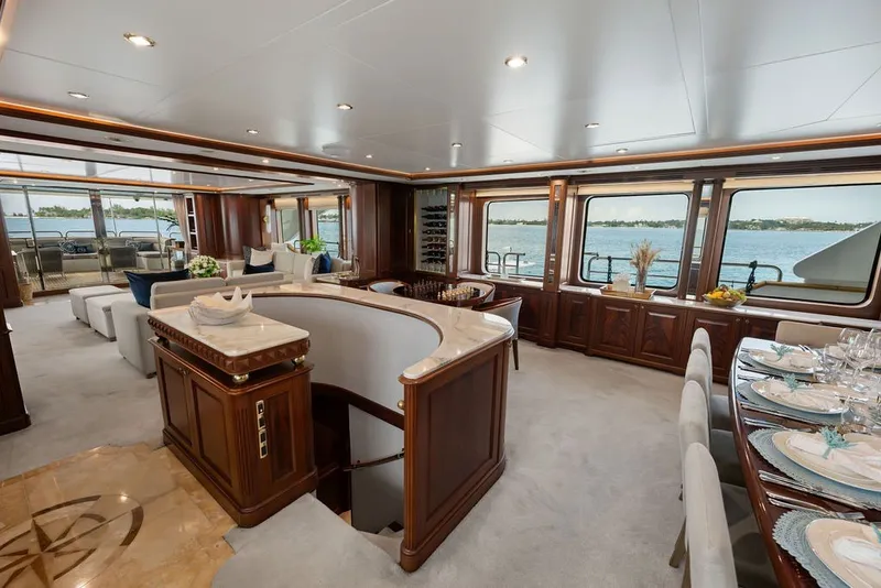 Slide: The Image of Luxurious interior of a 2007 Benetti 120 Classic yacht with elegant dining and seating areas. - 74