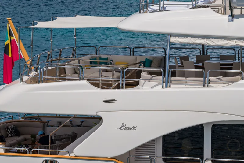 Slide: The Image of Luxury Benetti 120 Classic yacht, 2007 model, with elegant outdoor seating and ocean backdrop. - 11