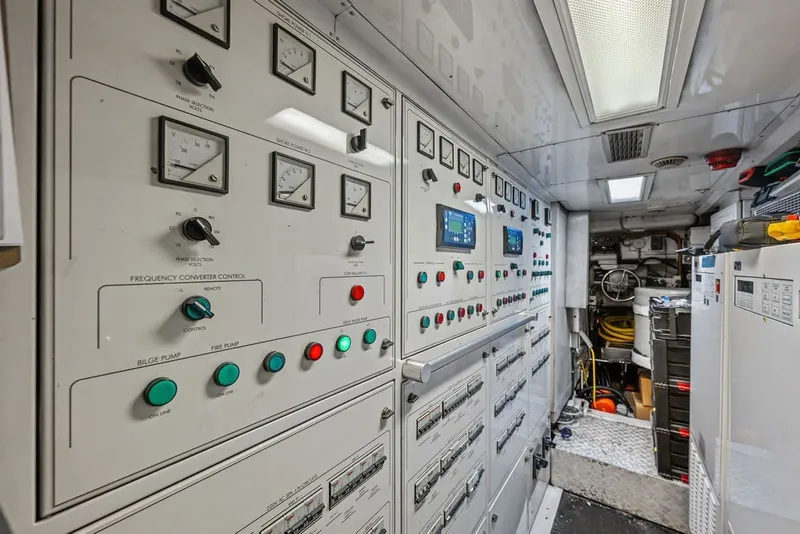 Slide: The Image of Control room of a 2007 Benetti 120 Classic yacht, featuring various gauges and switches. - 165