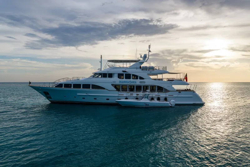 Slide: The Image of Luxury yacht Benetti 120 Classic 2007 on serene ocean at sunset. - 13