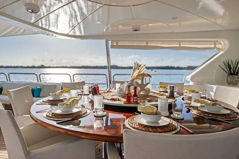 Slide: The Image of Luxurious dining setup on 2007 Benetti 120 Classic yacht, overlooking serene ocean view. - 147