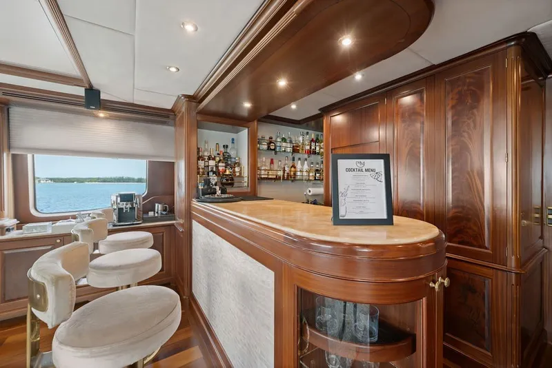 Slide: The Image of Luxurious bar area on a 2007 Benetti 120 Classic yacht with elegant wood finishes. - 83